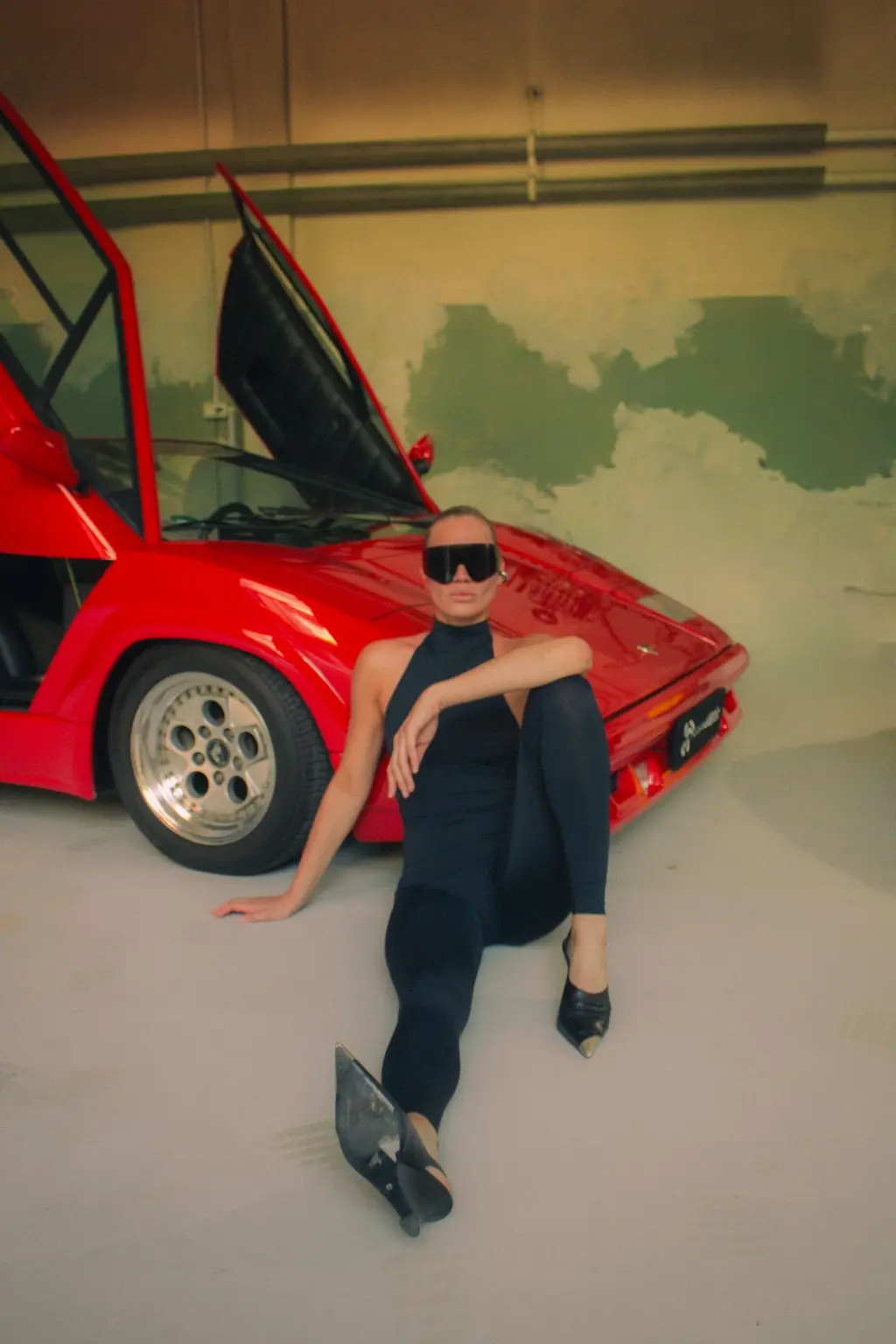 Alyona seated beside the Countach