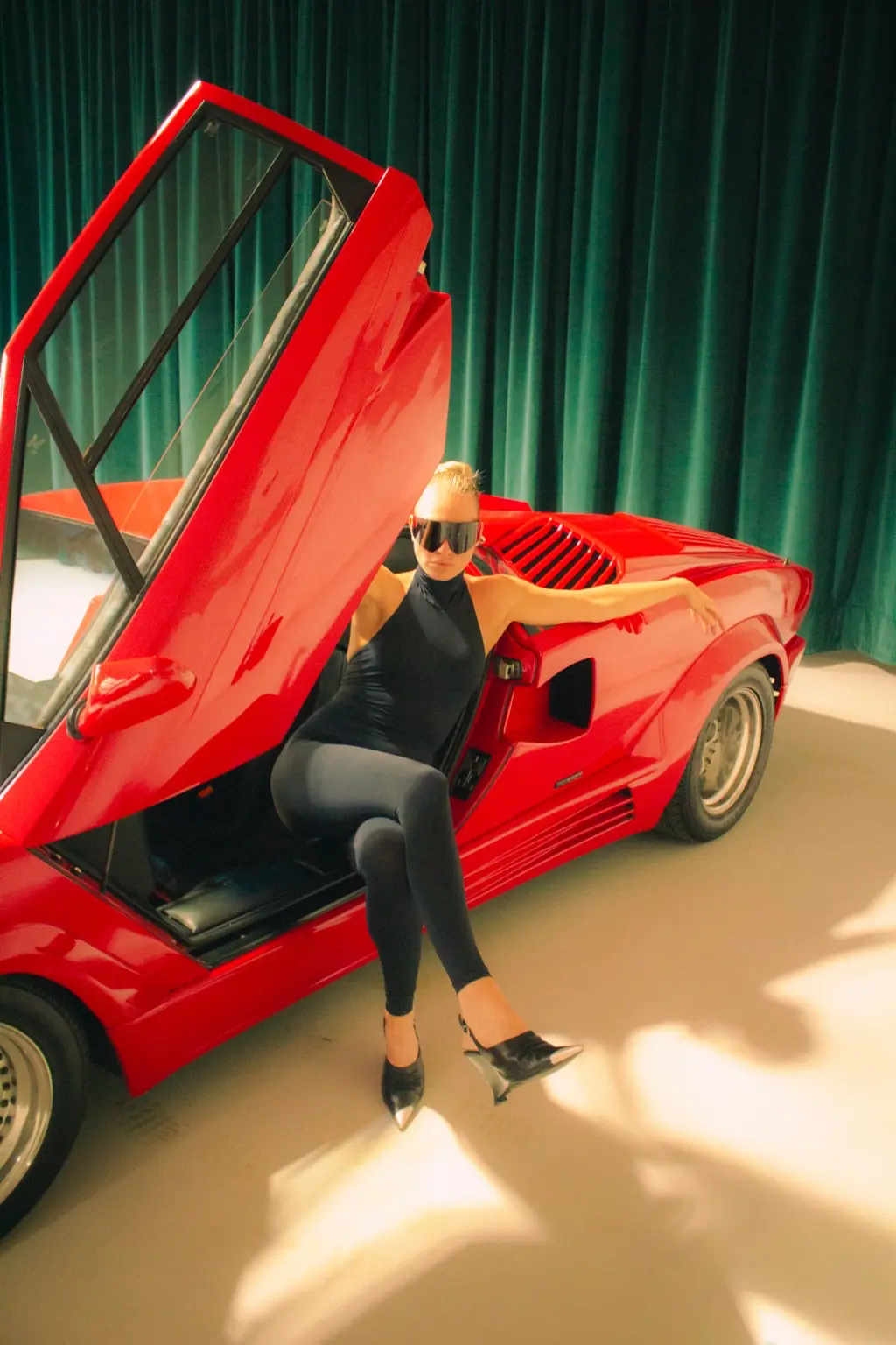 Fashion portrait with red Countach and black styling