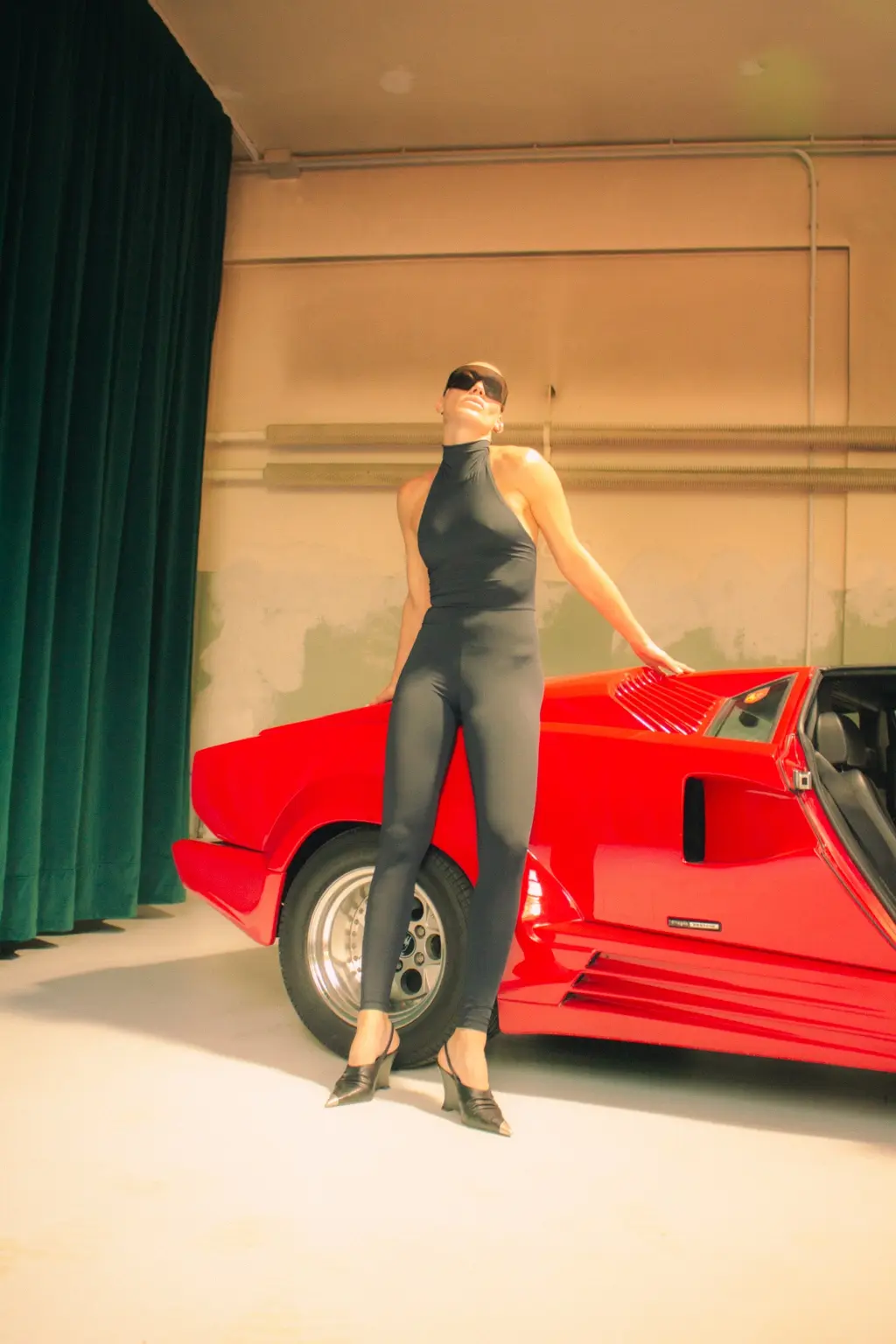 Alyona standing beside the red Countach