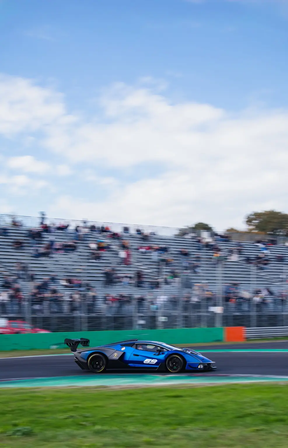 Blue racing Lamborghini captured at speed at Monza
