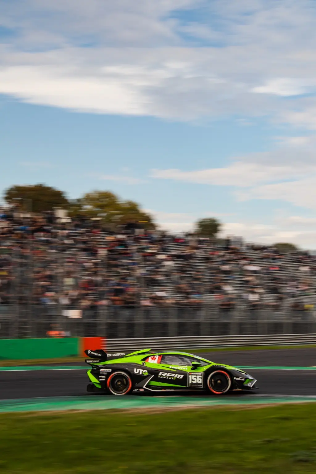 Green and black number 156 Lamborghini race car panning at Monza
